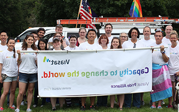 Viasat employee holding card during Pride