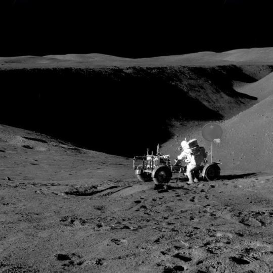 A man on the moon with a moon rover